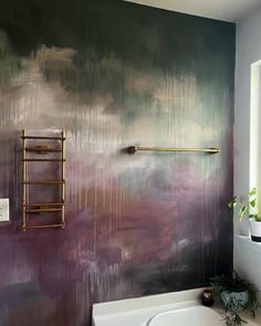 a bath room with a tub and a painting on the wall