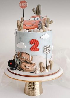 a birthday cake with cars on it and a stop sign