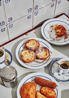 three plates with pastries and coffee on a table