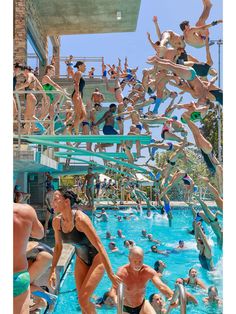 many people are in the swimming pool and one person is jumping into the water while others watch