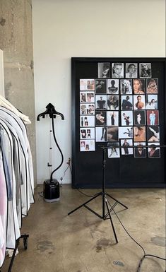 a black and white photo is hanging on the wall next to a tripod light