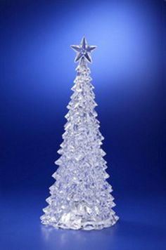 a clear glass christmas tree with a star on top, against a dark blue background