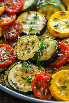 a pan filled with sliced up vegetables on top of a wooden table and topped with parmesan cheese