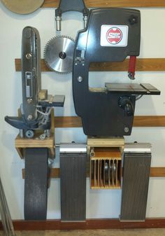 a machine that is sitting on top of a wooden shelf next to a sawduster