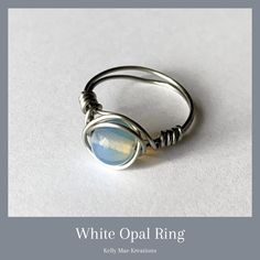 Opals protect from negative energy. Encourages independence & freedom. Brings out love, passion, faithfulness, & loyalty. This ring is made with a semi precious White Opal wrapped in Stainless Steel Wire and would be great for yourself or as a gift to a friend. #opalring #handmadering #bohorings #ringforsale #jewelrylover #jewelryforsale #customjewelry #workingmom #personalized #fashionjewelry #jewelrymaking #handcraftedjewelry #jewelryshop #personalizedgifts #bohochic #kellymaekreations Ring Wire, White Opal Ring, Stainless Steel Wire, Opal Ring, White Opal, Jewelry Lover, Boho Rings, Opal Rings, Negative Energy