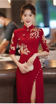 This cheongsam dress is made of high-quality fabric. You could have a good and comfortable fit by wearing it for a Chinese wedding or Tea ceremony. It is a very stunning red qipao dress with traditional Chinese flower embroidery. Qipao dress helps you look more slim and demonstrate a good body shape at your wedding. It would be excellently matched with the wedding shoes and wedding hair pins. If you are looking for an amazing unique design wedding dress, then this dress is very suitable for you. Elegant Chinese Dress, Chinese Gown Modern, Vietnamese Tea Ceremony Dress, Red Qipao Wedding, Cheongsam Dress Modern Chinese Style, China Dress Modern, Qipao Dress Modern Chinese Style, Chinese Tea Ceremony Dress, Chinese Inspired Dress