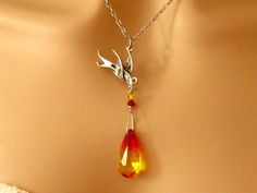 "Swarovski Phoenix Jewelry Gift for Her, Encouragement Necklace, Strength Necklace: Rebirth of an intricately detailed phoenix as it rises above the flames of a genuine Swarovski fire opal crystal in this beautiful Phoenix Necklace. This highly refractive crystal graduates from yellow to a fiery orangish red and is wire wrapped with two smaller Swarovski crystals onto the phoenix. The entire phoenix pendant hangs from a delicate antiqued silver plated chain. Phoenix Earrings: These long Swarovsk Phoenix Jewelry, Phoenix Necklace, Phoenix Pendant, Phoenix Bird, Symbol Necklace, Swarovski Crystal Bracelet, Bird Necklace, Bird Jewelry, Swarovski Crystal Earrings