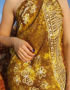 Beach sarong in brown and yellow print. One size. Size: 45"(112cm) x 66"(79cm) Multi use, wear as a sarong, beach cover up or use as a beach towel. Lightweight fabric. Composition: Mixed Sustainability: Vintage Bohemian Yellow Sarong For Beach, Yellow Bohemian Sarong For Beach, Yellow Bohemian Sarong For Summer, Yellow Beachwear Sarong For Beach Season, Yellow Sarong For Beach Season, Traditional Printed Sarong For Beach, Yellow Summer Sarong For Beach Cover-up, Yellow Summer Sarong For Beach, Yellow Summer Beach Cover-up Sarong