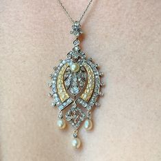 I'm a big admirer of the sort of high-quality, unfussy English workmanship on display in this 15-carat gold, natural pearl and diamond pendant.  It's from about 1880: the old mine cut diamonds are set in silver; the natural pearls are well-matched; and the bale is detachable.  In addition, there's a lightness of execution one doesn't usually see in English pieces of this time.  I'm extremely fussy about condition. I feel a duty to my clients about it, because it's just so important when it comes Victorian Pearl Drop Necklace, Victorian Pearl Necklace With Pearl Pendant, Victorian Style Diamond Pendant Necklace, Victorian Diamond Jewelry With Pearl Pendant, Antique Pendant Diamond Necklace For Wedding, Antique Diamond Pendant Necklace For Wedding, Antique Boxes, Silver Tops, Natural Pearl