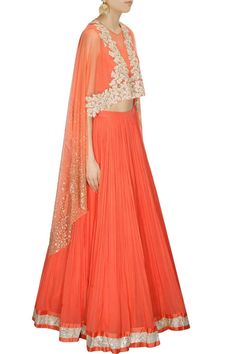 This Coral Lehenga Choli is features in cape top with floral embroidery and scattered sequins on sleeves. This coral lehenga choli comes along with matching chiffon pleated lehenga with silver border and coral shantoon sleeveless inner. This product is inspired from Ridhi Mehra Collection.