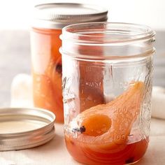 two jars filled with food sitting on top of a table