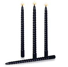 three black candles sitting next to each other