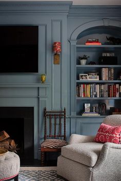 a living room filled with furniture and a flat screen tv mounted to a wall above a fireplace