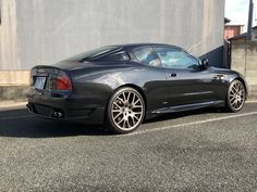 a black sports car parked in front of a building