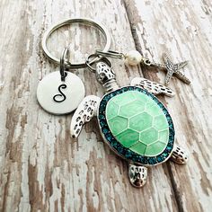 a sea turtle keychain with a starfish charm on it's side