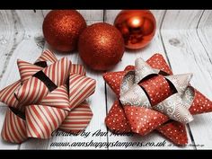 three red and white bows are on the table next to christmas ornaments, ornament balls