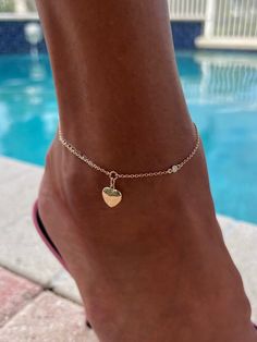 Lovely puffy heart anklet decorated with a diamond on the side and a diamond at the clasp drop, all on a 14K Solid Gold chain. Chain and heart are both all 14k Solid Gold.  Diamonds are 0.05ct each. Please select the chain metal from the drop-down menu. Anklet length can be customized. This listing is for the Enamored Heart Anklet Only.  All other anklets are sold separately  Visit my official website www.tatirocks.com and get 15% OFF all stock items! Use code BEACHLIFE at checkout. Coupon is valid only on my official website, NOT this Etsy site. * All photos are property of TatiRocks Jewelry. Use of these photos is prohibited unless permission is granted by TatiRocks Jewelry. Elegant Heart-shaped Anklets For Wedding, Elegant Wedding Anklets For Valentine's Day, Elegant Wedding Anklets, Elegant Adjustable Anklets With Heart Charm, Elegant Heart Charm Anklets For Valentine's Day, Elegant Heart-shaped Anklets For Valentine's Day, Elegant Gold Anklets With Heart Charm, Adjustable Heart Charm Anklets, Heart-shaped Anklets For Valentine's Day