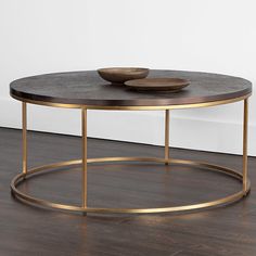 a coffee table with two bowls on top