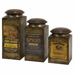 three tin canisters with labels on them