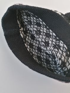 Knitted winter hat. Medium size available appr.56-58 cm head circmference. Traditional small nordic star pattern - dark grey or black variation is available. 100% lambs wool, without lining. Double edge, to keep hat more fit. This hat is unique - unisex model. Very well matching to men. There is used 2 basic colour for white star pattern: main colour is dark grey or black.. The edge has block striped pattern, red stripes included. Medium size - head circumference appr.56-58 cm, length 22 cm. Siz Black Knitted Beanie For Winter, Black Wool Hats For Cold Weather, Cozy Black Hats For Cold Weather, Cozy Warm Black Beanie, Cozy Warm Black Hat, Black Hand Knitted Beanie Cap, Black Wool Beanie For Winter, Cozy Black Knit Hat, Handmade Black Beanie