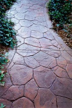 a stone path in the middle of some bushes