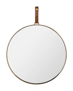 a round mirror with a leather strap hanging from it's side, against a white background