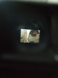 the reflection of a woman in a mirror on a car's side view mirror