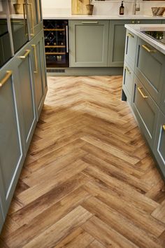 a kitchen with wood flooring and green cabinets