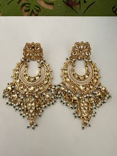 This intricately handmade pair with pearl drops is perfect for any traditional look.  You will definitely fall in love with these sabyasachi kundan earrings. Light weight and comfortable. One of our favourite picks for the wedding season . Be bold, be stylish, and be your best always. The weight of the earrings is 44 g. The length of the earrings is 9 cm. The width of earrings is 5 cm.