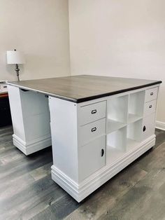 an office desk with two drawers and a lamp