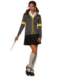 a woman dressed in a harry potter costume holding a wand and posing for the camera