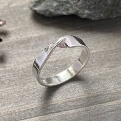 Handmade sterling silver Mobius twist ring. This sleek design looks great on everyone. Comes in a high polish finish. Very comfortable to wear. Dimensions: 1mm x 4mm wide. SIZES: 3-16 MORE SILVER RINGS: https://www.etsy.com/ca/shop/JenniferWoodJewelry?ref=seller-platform-mcnav§ion_id=37080248  Established Etsy Seller since 2006. Get 15% off when you join my email list to receive monthly updates about new work and subscriber-only deals. No spam. Just a lot of shiny new things. Subscribe at: http: Twisted Silver Rings For Anniversary, Modern Twisted Rings As A Gift, Sterling Silver Twisted Rings With Modern Style, Silver Twisted Rings For Wedding, Silver Twisted Wedding Rings, Silver Twisted Ring For Anniversary, Modern Twist Stackable Rings For Anniversary With Polished Finish, Twisted Sterling Silver Rings, Modern Twisted Sterling Silver Rings