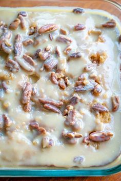 a casserole dish with nuts and cream in it on a wooden table top