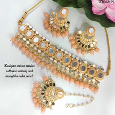 Description: Enhance your elegance with this stunning Traditional Indian Kundan Necklace Set featuring matching earrings, meticulously crafted to perfection. This exquisite jewelry set is the epitome of luxury, blending traditional design with contemporary flair, making it a must-have for every jewelry collection. Product Features: Material: High-quality Kundan stones, gold-plated alloy, and pearl detailing. Design: Intricately designed with a beautiful combination of green and pink beads that add a pop of color, perfect for any occasion. Earrings: Matching earrings with a comfortable fit, complementing the necklace perfectly. Necklace Length: Adjustable with a drawstring closure to suit your neckline and preference. Occasion: Ideal for weddings, bridal wear, engagements, festive occasions Dual-tone Bollywood Wedding Jewelry, Dual-tone Bollywood Jewelry For Wedding, Elegant Dual-tone Kundan Jewelry Sets, Elegant Kundan Jewelry Sets In Dual-tone, Elegant Kundan Dual-tone Bridal Necklace, Elegant Dual-tone Kundan Bridal Necklace, Elegant Meenakari Metal Jewelry Sets, Elegant Dual-tone Chandbali Jewelry Sets, Elegant Dual-tone Kundan Necklace For Wedding