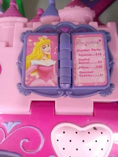 there is a pink and purple toy with princesses on it