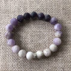 Add a dash of purple plus a boost of immunity with our 10 mm beaded ombre amethyst bracelet. Amethyst is known to aid sleep and enhance your immune system. And this gorgeous gem features all sorts of shades of amethyst in an ombre design with silver accents. This bracelet pairs well with our Deep Purple Amethyst Bracelet. Bracelets measure 6.25 inches around. But wrists come in different sizes, and so do our bracelets! If you want larger or smaller, simply specify when you order. Lavender 8mm Beads Jewelry For Healing, Lavender Amethyst Beaded Bracelets For Meditation, Spiritual Lavender Bracelets With Natural Stones, Lavender Natural Stones Spiritual Bracelet, Lavender Hand-strung Spiritual Bracelets, Lavender Hand-strung Spiritual Bracelet, Holistic Amethyst Bracelet For Meditation, Lavender Spiritual Hand-strung Bracelet, Spiritual Lavender Hand-strung Bracelet