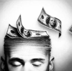 a man with money on top of his head and one dollar bill above his head