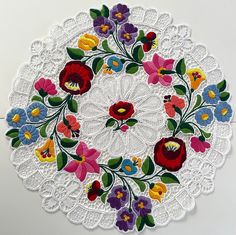 a white doily with colorful flowers on it