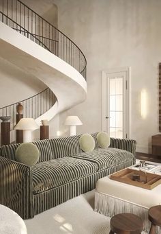 a living room filled with furniture and a spiral staircase