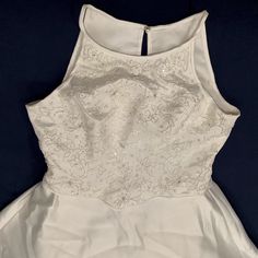 the back of a white wedding dress on display