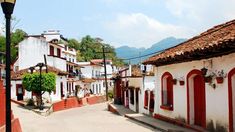 an empty street lined with white and red buildings