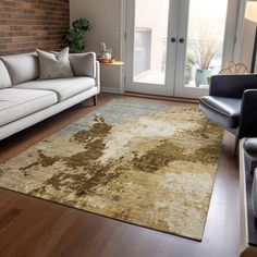 a living room filled with furniture and a rug on top of a hard wood floor