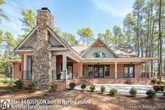 a brick house in the woods surrounded by pine trees