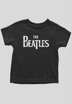 Must Have item for any Little Rocker! An officially licensed Tee featuring the The Beatles 'Drop T Logo' design motif. Soft-style cotton toddler's tee featuring short sleeves and crew neck collar from 12 months through 5 years old. This high quality Tee is available in a black colourway. T Logo, Logo Tees, Neck Collar, Soft Style, Baby Wearing, Black T Shirt, Shirt Price