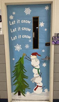 a door decorated to look like a snowman with a christmas tree on it and the words let it snow, let it snow