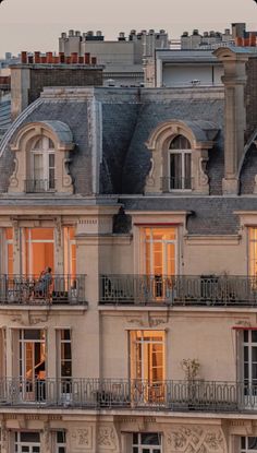 an apartment building with lots of windows and balconies on the top floor in paris