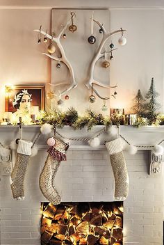 christmas stockings hanging from the mantel over a fireplace