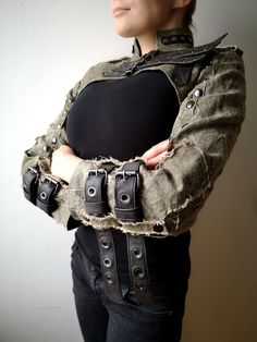 "One of a kind short jacket made out of worn out army green military surplus waxed canvas. Decorated with gunmetal color studs and buckles. Standing collar, straps. Buckles to get in. Fully lined. Size: Medium/Large Bust 38-43\"' Measurements: 19\" from armpit to armpit along the back, 16\" from shoulder seam to shoulder seam (all together there's room for 17-18\" wide shoulders) 6\" from collar to bottom along the back 22 1/2\" from shoulder to end of sleeve 11\" around wristband, 14\" around b Wasteland Fashion, Apocalyptic Wasteland, Dream Warriors, Military Dresses, Army Jacket, Leather Detail, Studded Leather, Post Apocalyptic, Short Jacket