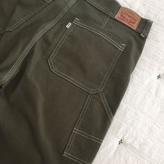 Levi’s Olive Green Carpenter Style Pants, Unique Stitching. 25” Inseam, 7” Wide Hem. Excellent Condition Never Worn. Unique Levi's Utility Straight Leg Bottoms, Levi's Cotton Utility Bottoms, Levi's Cotton Bottoms With Patch Pockets, Levi's Cotton Work Pants, Levi's Cotton Workwear Pants, Levi's Cotton Jeans For Work, Levi's Cotton Workwear Bottoms, Levi's Cotton Bottoms With Hip Pockets, Levi's Cotton Cargo Bottoms