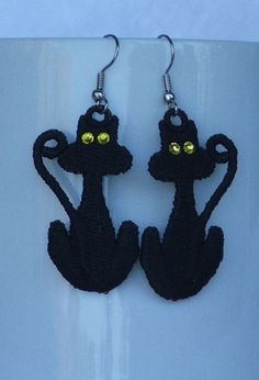 These cute kitties are perfect for the Halloween season (although they would be fun any time of year!) These black cat earrings have a Swarovski crystal in the eyes for extra sparkle!  They are designed by Sonia Showalter, and stitched by Deborah in PA, USA. These earrings are great for both children and adults, and are light and airy.  They are made of surgical steel earwires, so no worries about allergies! 100% handmade by Deborah in the USA Black Cat Design Earrings For Halloween, Black Cat Ears Earrings For Halloween, Black Cat Ears Earrings For Party, Cute Black Pierced Jewelry, Cute Black Cat Design Earrings, Handmade Fun Black Earrings, Handmade Black Novelty Earrings, Fun Handmade Black Earrings, Fun Black Hypoallergenic Earrings